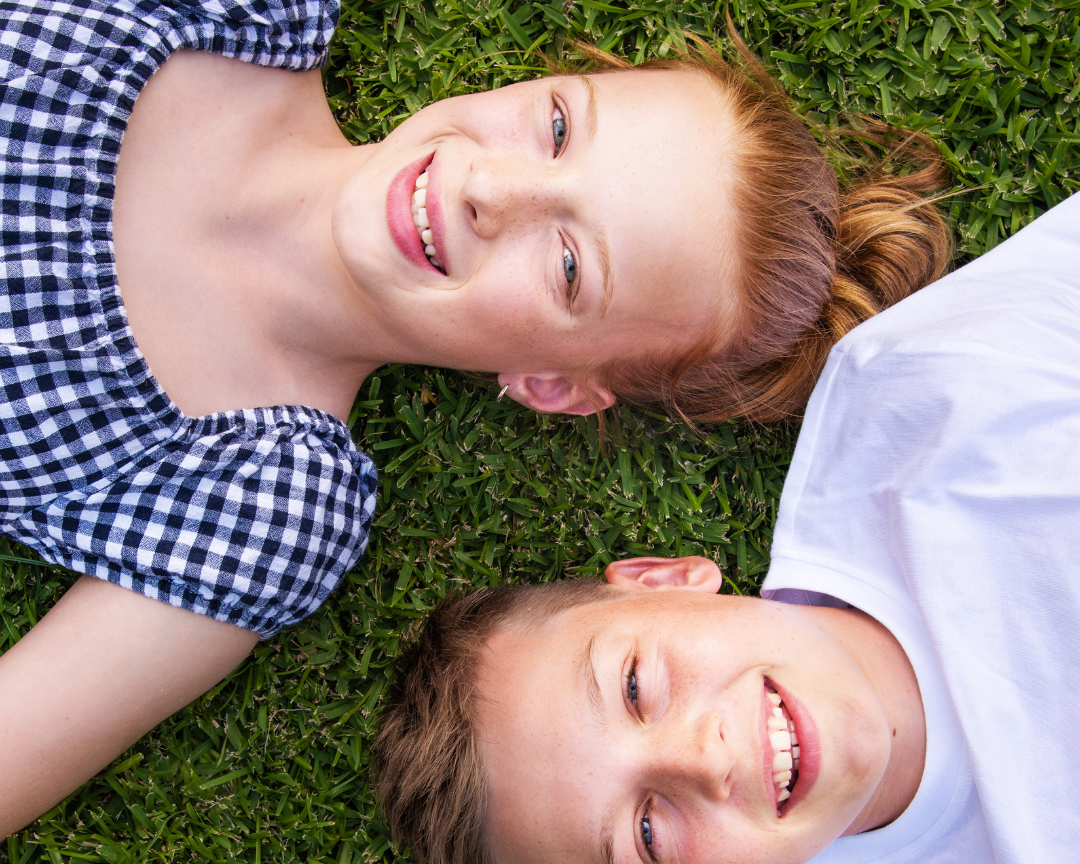 Two kids lying in the shade